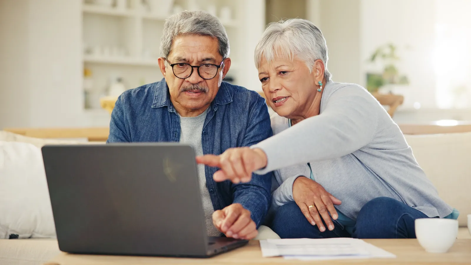 man and woman looking at a laptop